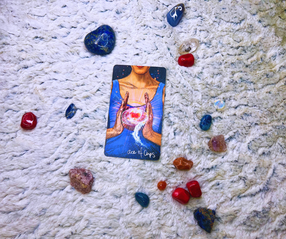 Photo of the ace of cups tarot card with surrounding crystals